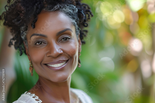 Portrait of middle aged African American woman with beautiful healthy skin. Beautiful happy woman 50-60 years old smiling.