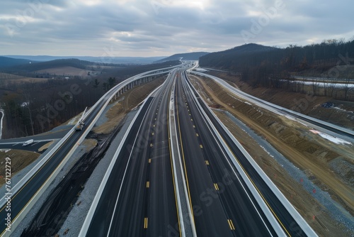 Overhead view of a busy highway with numerous lanes and vehicles moving in different directions