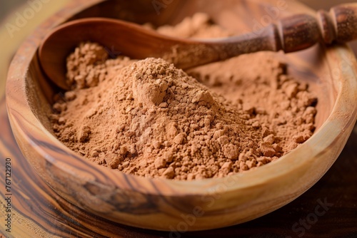 sandalwood powder in a wooden bowl with a spoon