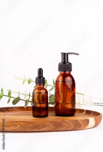 Set of natural organic SPA beauty products on wooden board isolated on white background. Amber glass spray bottle, homemade soap, serum. Bio cosmetics branding, packaging design..