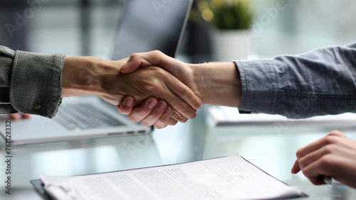 Handshake in the office close-up at the table