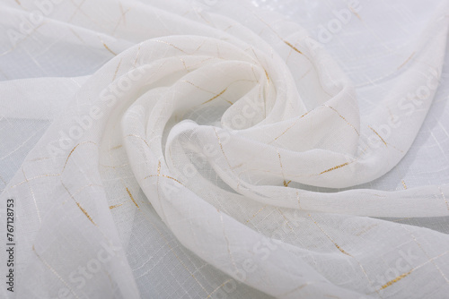 The fabric is white, rolled up by the inversion of the waves. Folds of the curtain in the form of a flower.