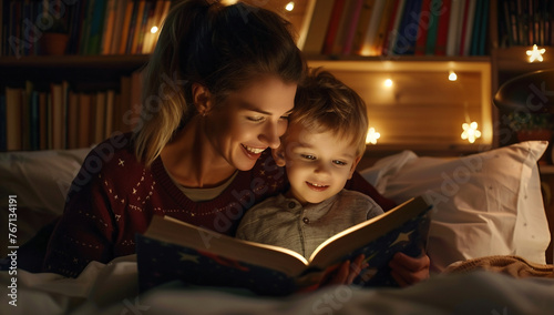 Happy mom listening to her toddler son holding bedtime story book learning reading in bed at night.Reading for helps kids' brain development concept.