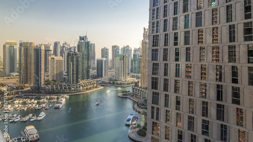 Canvas Print Beautiful aerial view of Dubai Marina promenade and canal with floating yachts and boats before sunset in Dubai, UAE