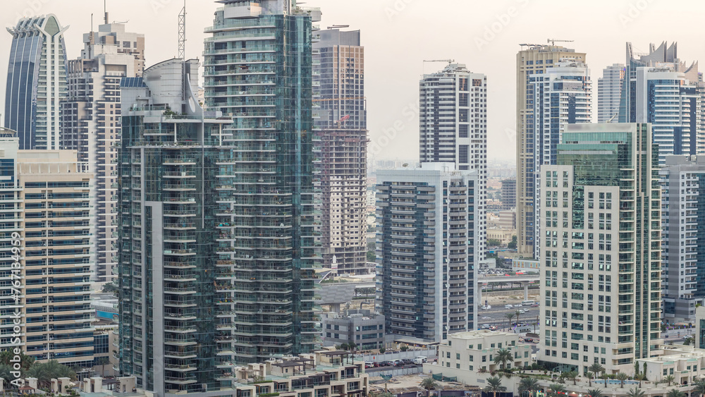 Obraz premium Luxury Dubai Marina canal with passing boats and promenade day to night timelapse, Dubai, United Arab Emirates