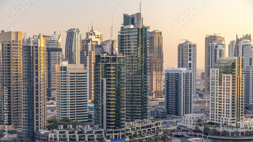 Beautiful aerial view of Dubai Marina promenade and canal with floating yachts and boats before sunset in Dubai  UAE.