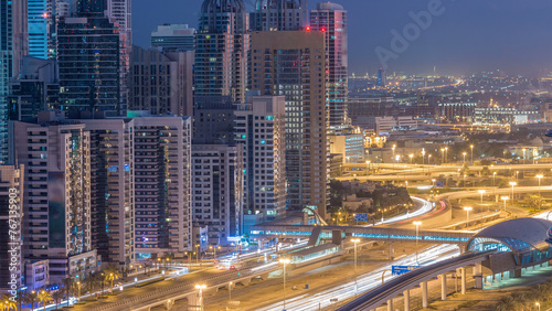 Dubai Marina skyscrapers aerial top view before sunrise from JLT in Dubai night to day timelapse, UAE.