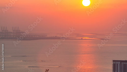 Fototapeta Naklejka Na Ścianę i Meble -  Sunset over Bluewaters island aerial timelapse