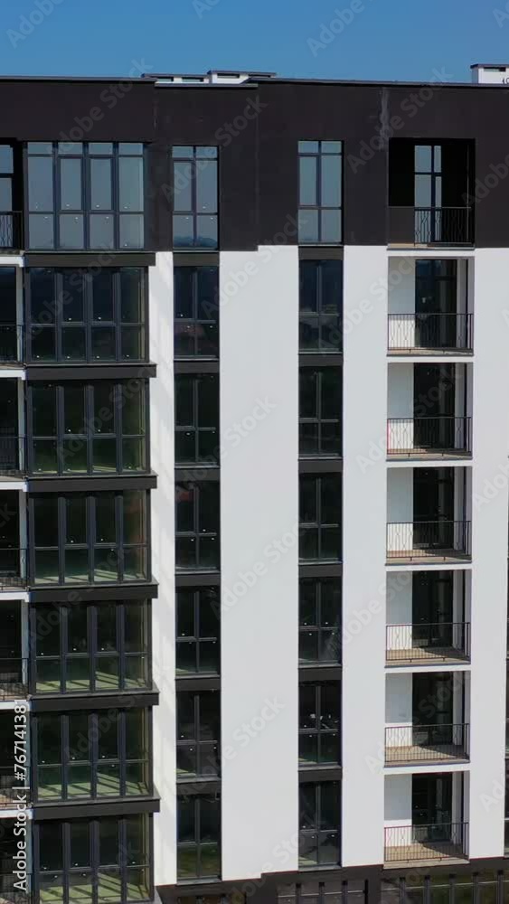 New high-rise residential building in city suburb. New apartment houses. Video of modern buildings. Vertical video New high-rise residential building in city suburb. New apartment houses. Video of modern buildings. Vertical video