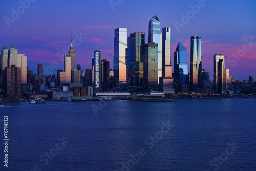WEEHAWKEN, NJ -18 FEB 2024- Sunset view of the waterfront skyline in Manhattan, New York, seen from across the Hudson River in New Jersey. © eqroy