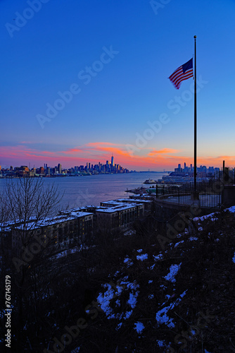 WEEHAWKEN, NJ -18 FEB 2024- Sunset view of the waterfront skyline in Manhattan, New York, seen from across the Hudson River in New Jersey. © eqroy