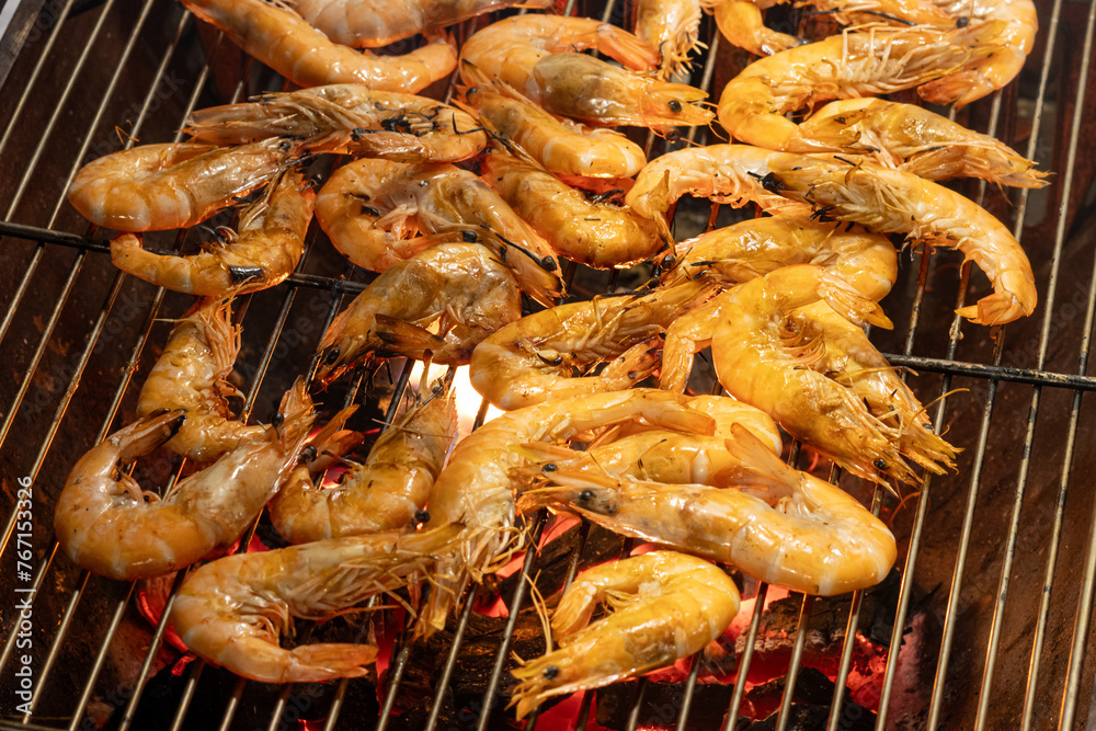 Prawns are grilled on a grid
