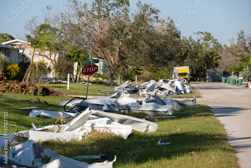 Metallic scrap rubbish on roadside from hurricane severely damaged houses in Florida residential area. Aftermath of natural disaster