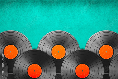 Nostalgic Array of Vintage Vinyl Records on a Bright Teal Background