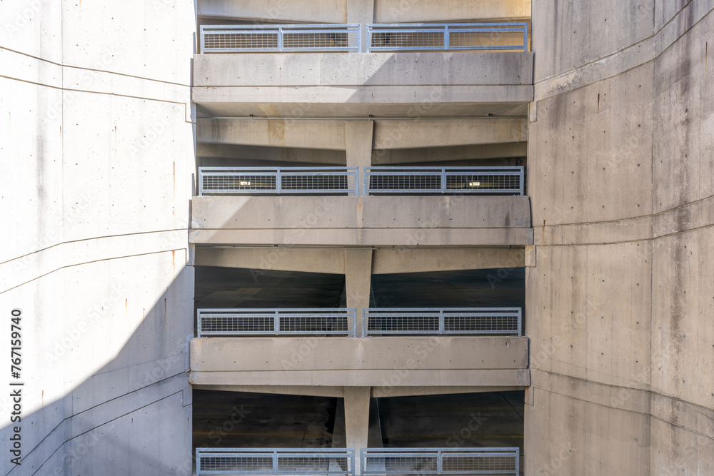 Fototapeta premium Elevation view of a multi level concrete parking garage, car park, during the day.