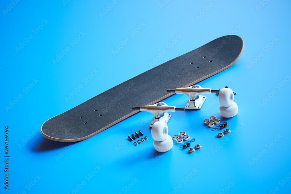 Disassembled Black Skateboard and Components on Bright Blue Surface