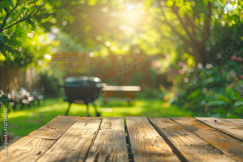 Summer time in backyard garden with grill BBQ, wooden table, blurred background.