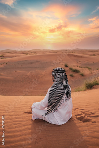 Photography Young man praying in desert during ramadan month