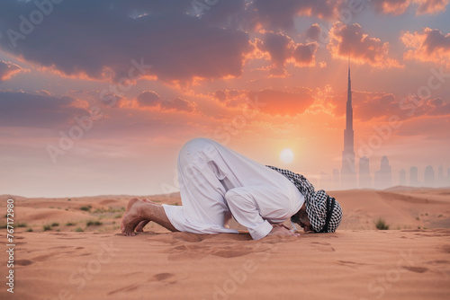 Young man praying in desert during ramadan month © _chupacabra_