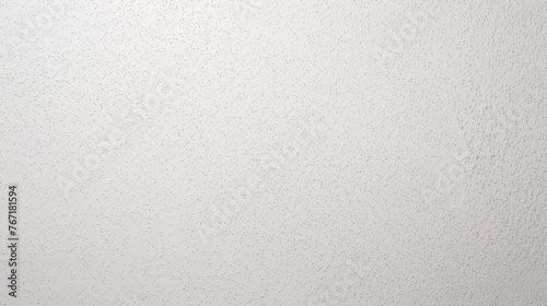 White textured wall in tiny black dots. Gypsum plaster background.