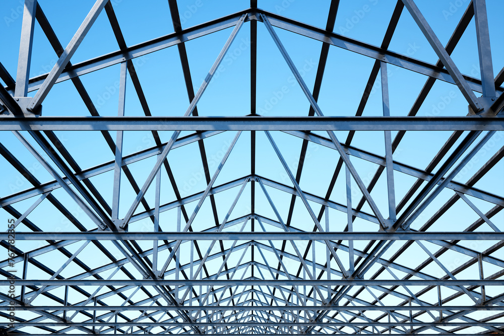 Innovative Geometric Steel Framework Captured Against a Vibrant Blue Sky