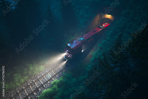 Aerial Shot: Red Cargo Train Exiting a Tunnel into a Mysterious Forest at Night
