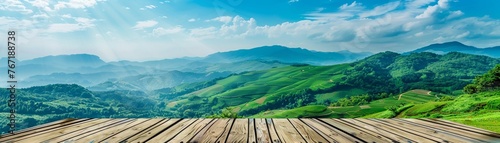 A wooden podium offers a breathtaking view of vibrant green rolling hills under a blue sky