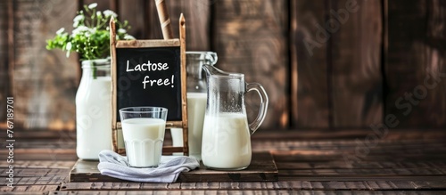A jug and glasses with lactose-free milk on the table
