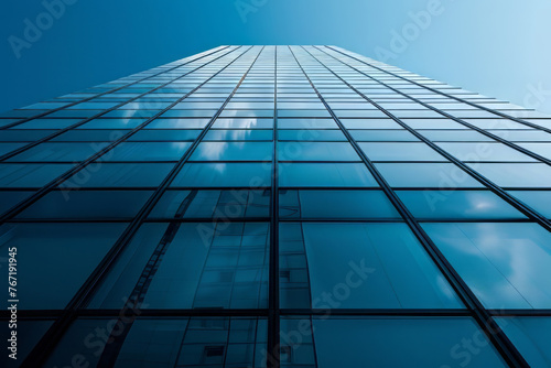 modern glass clean business building on a blue sky background, bottom-up view