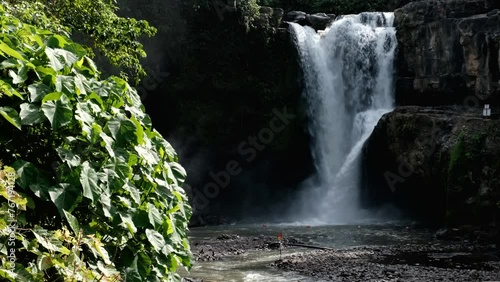 Tripod footage of Tegenungan waterfall without people on sunny day. Bali, Indonesia. photo