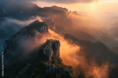 Sunset over mountain peaks with misty valleys  © JJ1990