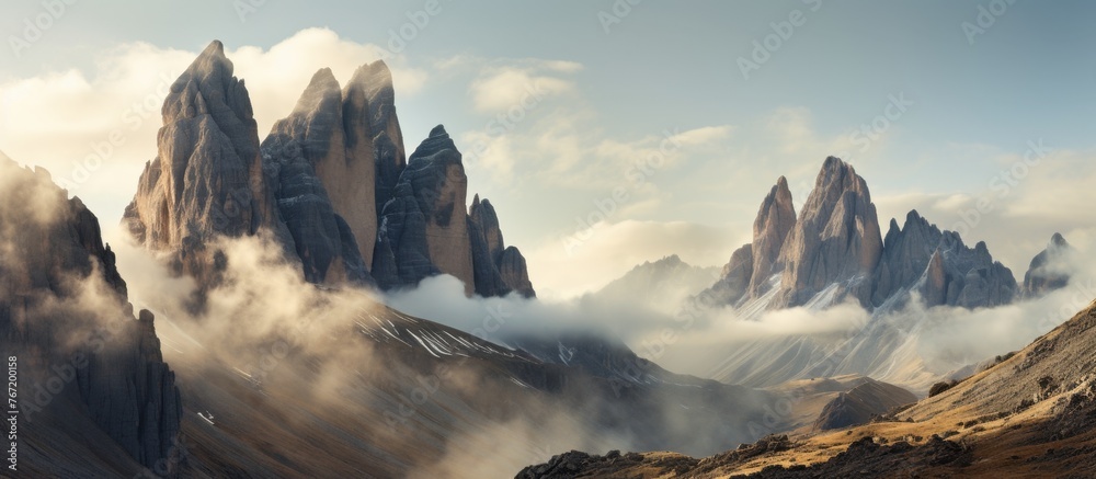 A breathtaking natural landscape of a mountain range covered in cumulus clouds, with a brilliant blue sky in the background. Perfect for art inspiration or travel adventures - obrazy, fototapety, plakaty 