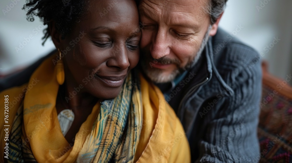 A tender moment between two people sharing a warm embrace with one resting their head on the other's shoulder both smiling gently evoking a sense of love and comfort.