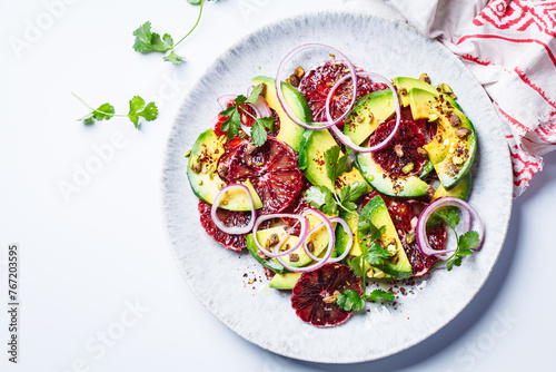 Blood oranges salad with avocado, pistachios and red onions.