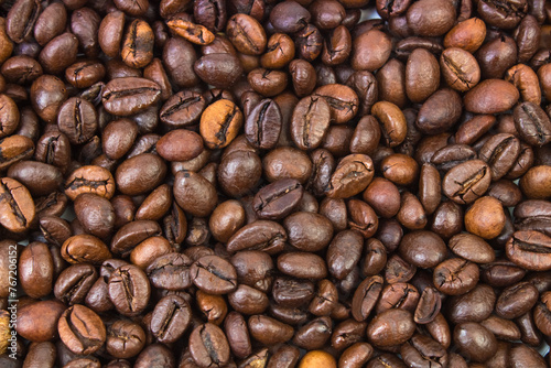 Top view background of aromatic brown coffee beans scattered on surface 