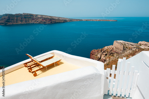 Santorini island  Greece. Two chaise lounges on the terrace with sea view.