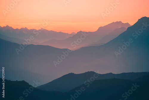 Beautiful mountains in the pink foggy sunset. Abstract nature background.
