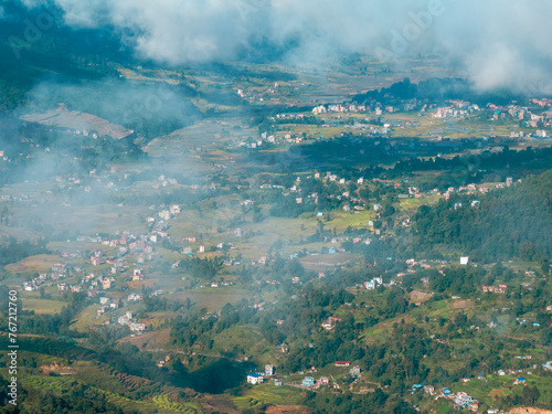 Aerial view of some Nepalese villages surrounded by nature and rice fields in the valleys at the foot of the Himalayan mountain range, seen from Nagarkot. Nepal