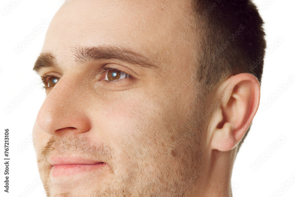 Close up of handsome young man with stubble looking away against white studio background. Double chin prevention. Concept of natural beauty, spa treatments, masculine, cosmetology.