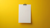 Pinned white note paper on a bright yellow wall