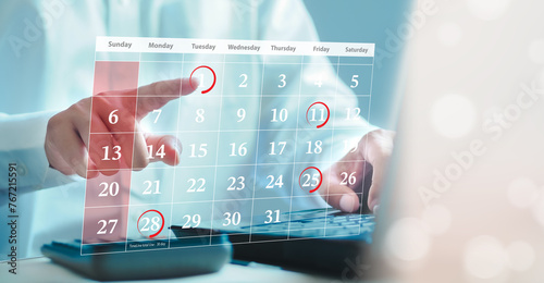 Businessman schedules meeting planning and marks red circle to Laptop reminders with scheduled appointments on the calendar. Schedule an activity photo