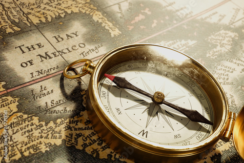 Navigating History: Vintage Brass Compass on an Ancient World Map