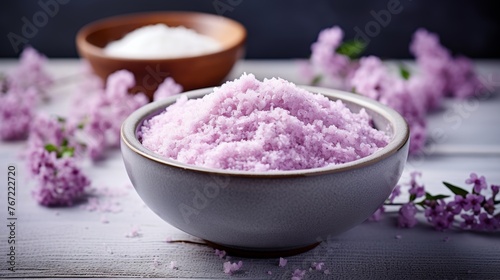 Lavender bath salt in wooden bowl on concrete background with free copy space for text