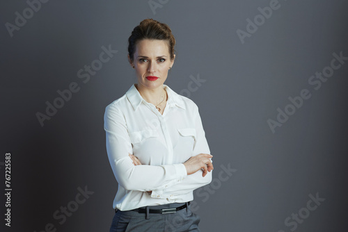 stylish small business owner woman against gray background