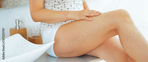Closeup on young woman checking leg skin softness