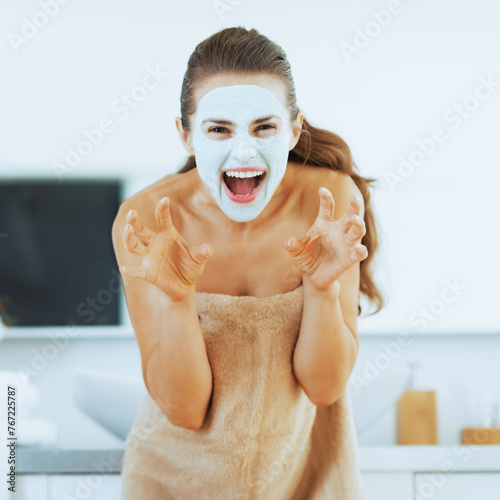 Young woman with cosmetic mask on face scaring