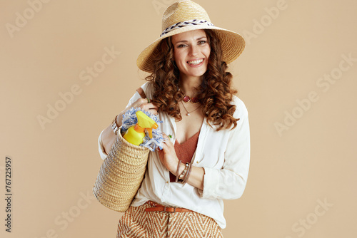 smiling elegant woman in blouse and shorts on beige