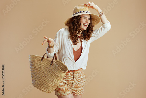 smiling trendy woman in blouse and shorts