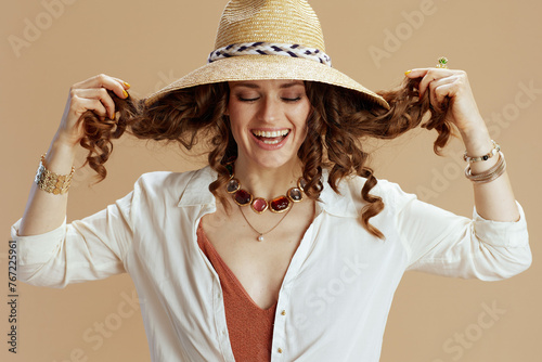 smiling woman in blouse and shorts isolated on beige