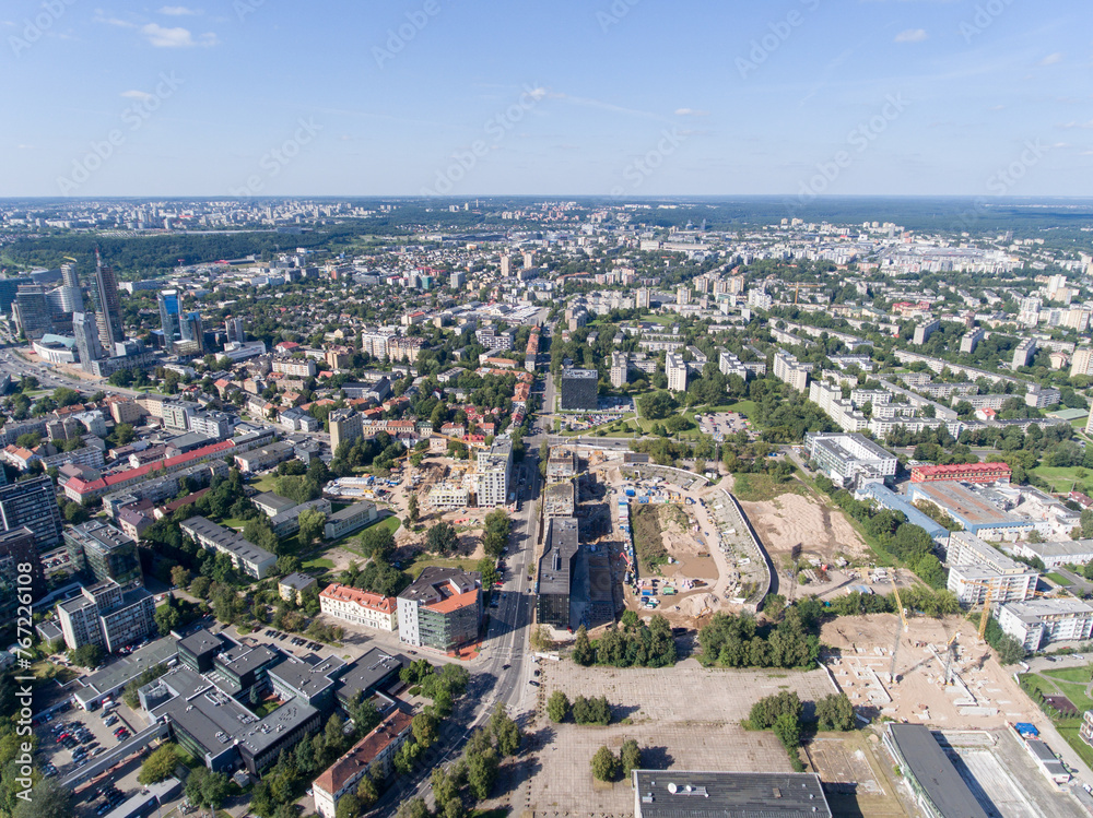 Vilnius City Cityscape, Lithuania. Snipiskes Zirmunai District, Business Town in Background. Drone Point of View. Abandoned Zalgiris Stadium